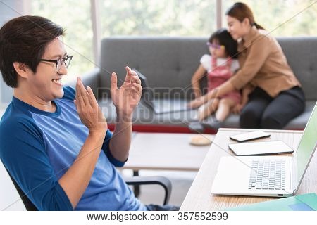 Asian Businessman Father Working At Home Talking To Team With Happiness In Online Meeting While His 