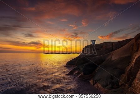A Colorfull Sunset With The Small Lighthouse At Stångehuvud In Western Sweden