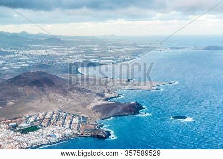 Airplane Aerial View Of Coastal Landscape And Town Of Arinaga On Gran Canaria Island With Ocean, Hil