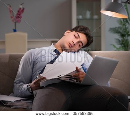 Businessman workaholic working late at home