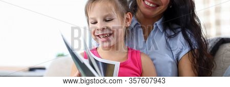 Portrait Of Beautiful Mother Teaching Declaiming Happy Daughter. Lovely Woman And Little Girl Lookin