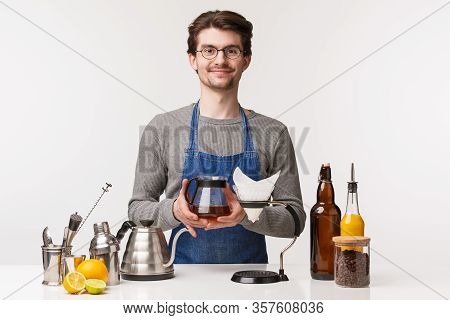 Barista, Cafe Worker And Bartender Concept. Friendly Cheerful Young Guy Employee In Store Wearing Ap