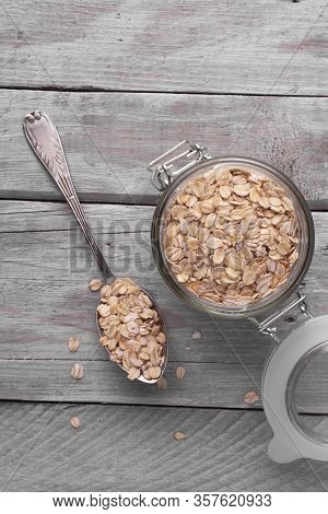 Oatmeal With A Glass Jar On An Old Wooden Table. View From Above.