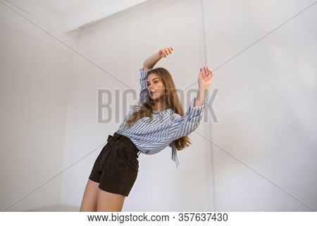 Young Beautiful Girl Is Dancing In The Style Of Contemp.