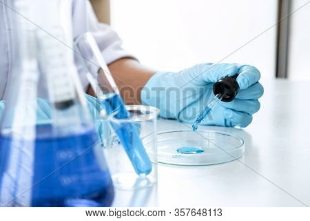 Biochemistry Laboratory Research, Scientist Or Medical In Lab Coat Holding Test Tube With Using Reag