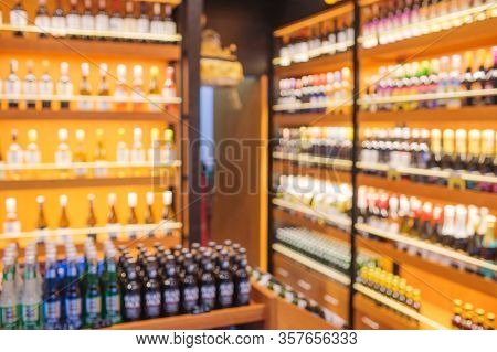 Background Blurred Defocused Beers Are Cooling In Fridge, Freezer Or Refrigerator Shelf. Defocused B