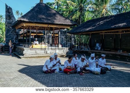 Bali, Indonesia 27 June 2017 : Buddhists Praying At Tirta Empul Temple In Bali, Indonesia. It Has Ho