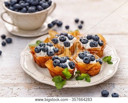 Phyllo Cups With Mascarpone Cheese Filling Topped With Fresh Blueberries Sprinkled With Powder Sugar