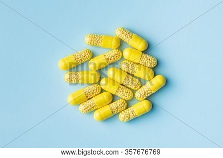 Vitamin capsules. Vitamin C pills on blue background. Top view.