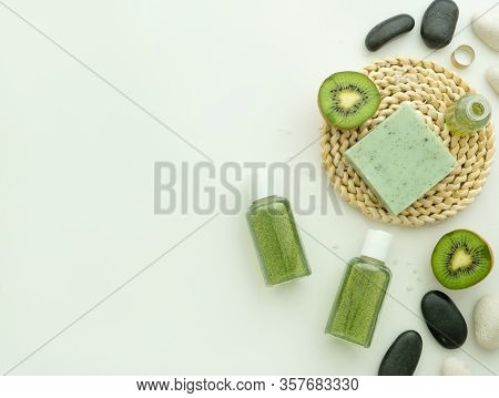 Shampoo, Liquid Soap, Kiwi Fruits, And Spa Stones, Male Ring, Soap Bar On Hassock Mat Isolated On Wh