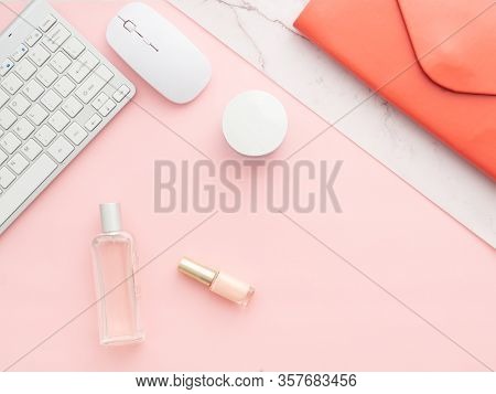 Flat Lay, Top View Of Pink Table Desk Frame. Feminine Desk Workspace With Laptop, Red Folder Clutch,