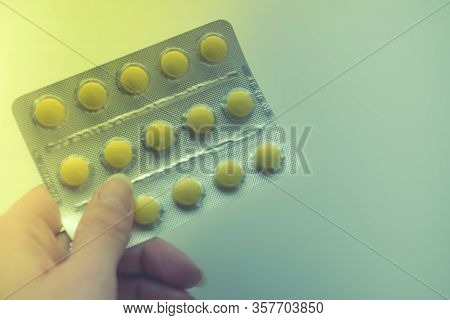Blister With Yellow Vitamins Or Pills In Female Fingers, Copy Space.