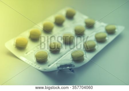 Blister With Yellow Vitamins Or Pills On The Table, One Vitamin Is Already Eaten, Close-up, Side Vie