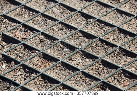 Plastic Geonet Reinforcement On The Soil To Hold The Ground At The Construction Site, Close-up And D