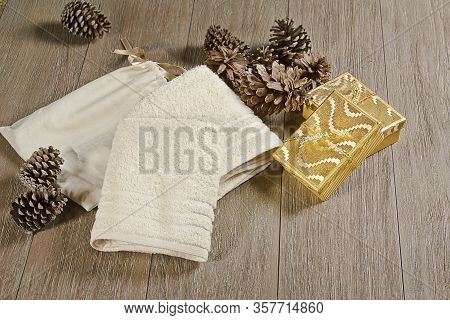 Christmas decoration wreath on the dark vintage wooden background. Gift boxes, wreath and golden sta