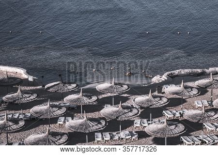Hotel Deserted Beach. Sun Loungers And Umbrellas. A Threat To The Tourism Business. Nobody Ashore