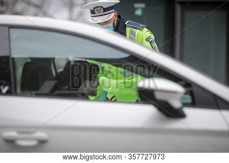 Romanian Road Police Officer Pulls Over A Car To Check For The Driver’s Identity Papers.