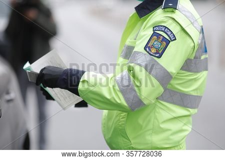 Romanian Road Police Officer Pulls Over A Car To Check For The Driver’s Identity Papers.