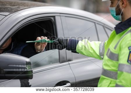 Romanian Road Police Officer Pulls Over A Car To Check For The Driver’s Identity Papers.
