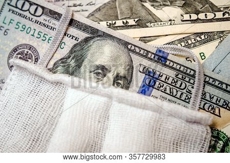 A Hundred-dollar Bill With A Medical Mask .the Concept Of Coronavrius Epidemic