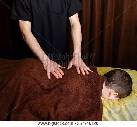 Young Boy Toddler Relaxes From A Therapeutic Massage