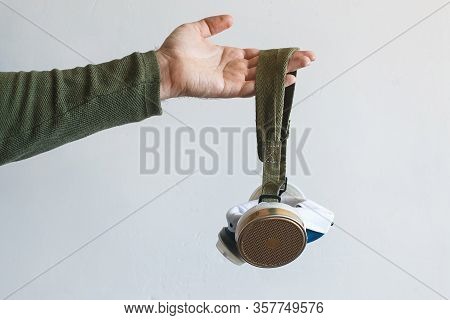 Respirator In Male Hands. The Concept Of Protection Against Viruses And Diseases. Virus Worldwide Co