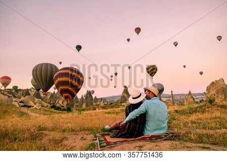 Cappadocia Turkey During Sunrise, Couple Mid Age Men And Woman On Vacation In The Hills Of Goreme Ca