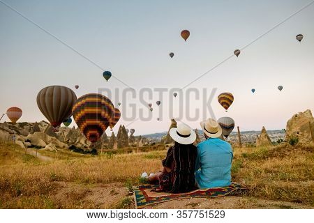 Cappadocia Turkey During Sunrise, Couple Mid Age Men And Woman On Vacation In The Hills Of Goreme Ca