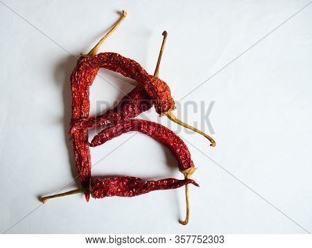 Letter B Lined With Red Peppers On A White Background. Symbol In The Form Of The Letter B. Pepper Li