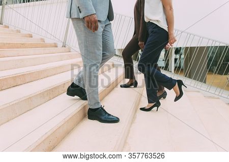 Businesspeople Moving Upstairs And Downstairs. Legs And Feet Of Business Man And Women Wearing Forma