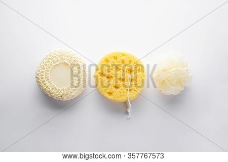 Three Different Bath Sponges On A Gray Background, Flat Lay. Bath Accessories. Hygiene Products.