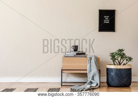 Modern Scandinavian Living Room Interior With Black Poster Frame, Design Commode, Basket And Elegant