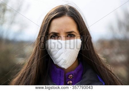 Young Woman Wearing A Protective Surgical Face Mask During The Coronavirus Disease Covid 19 Outbreak