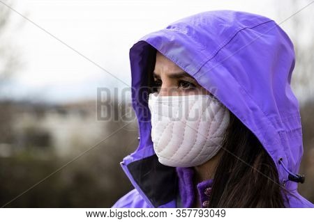 Young Woman Wearing A Protective Surgical Face Mask During The Coronavirus Disease Covid 19 Outbreak
