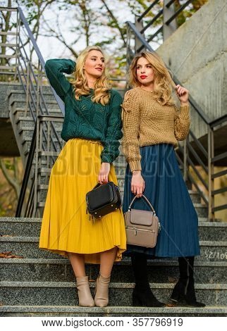 Charm. Stylish Autumn Women Outdoor. Girl Friends Go Upstairs. Fall Season Color Trends. Pleated Tre
