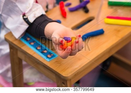 .child Playing With Plasticine And Making Molds