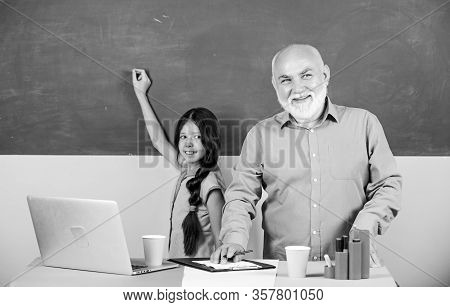 Towards Knowledge. Ature Teacher Help School Girl. Little Girl With Man Tutor Study On Laptop. New T