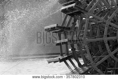 Black And White Close Up Of An Old Paddle Wheel On The River