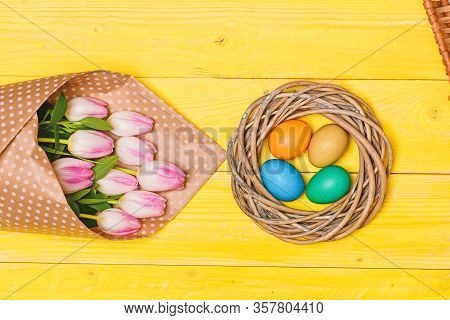 Spring Vibes. Colorful Bright Eggs And Bouquet Fresh Tulip Flowers On Yellow Background Top View. Sp