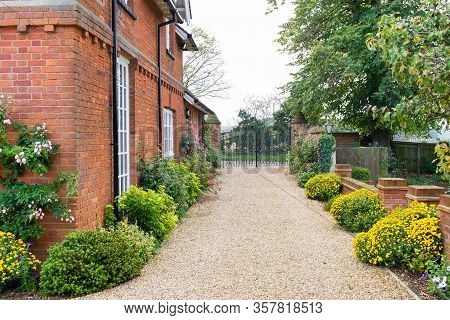 Large English Country Mansion House From Victorian Period In The Uk, With Wrought Iron Gates And Gra