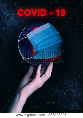 A Female Hand Holds The Globe With A Medical Mask During An Epidemic Of Covid 19 Or Coronavirus Worl
