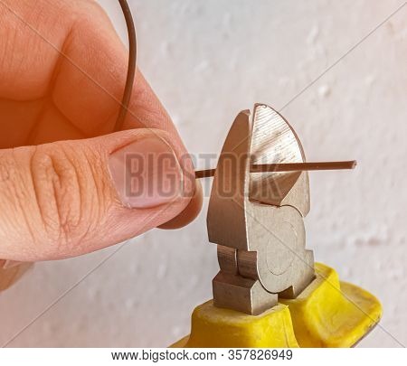 Wire Stripping With Pliers Close Up. Handman At Work.