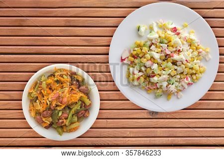 Crab Salad On A White Plate With Vegetarion Salad. Crabs Salad On A Orange Wooden Background Top Vie