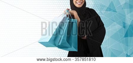 Arabic Woman Holding Shopping Bags Standing On Blue Background. Arab Shopping Concept.