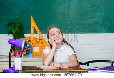 Hooked On Learning. Girl Cute Child Sit School Classroom Chalkboard Background. Small Kid Study Scho