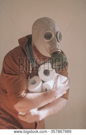 Man In Gas Mask With A Lot Of Toiler Paper In Hands