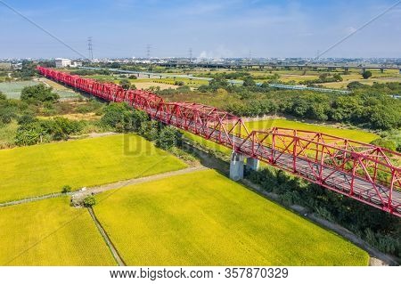 red famous Xilou Bridge over the river and farm in Yunlin county, Taiwan