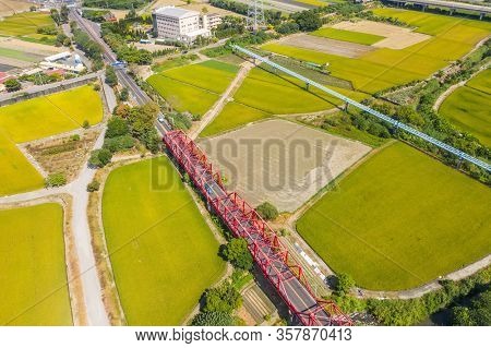 red famous Xilou Bridge over the river and farm in Yunlin county, Taiwan