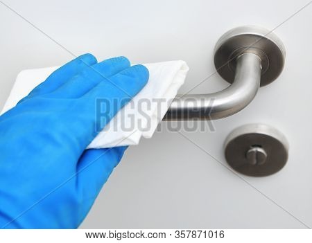 Disinfection In Public Places, The Fight Against The Virus, Coronavirus.worker's Hand Wipes The Door