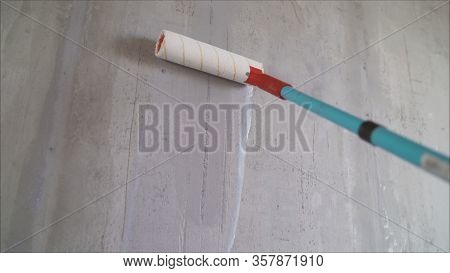Paint The Bare Wall With A Paint Roller. Hand Painted By Roller. Primer Wall Roller